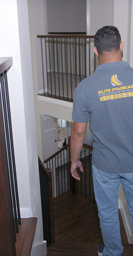 a member of the elite staircases team checking newly installed staircase and railings round rock tx