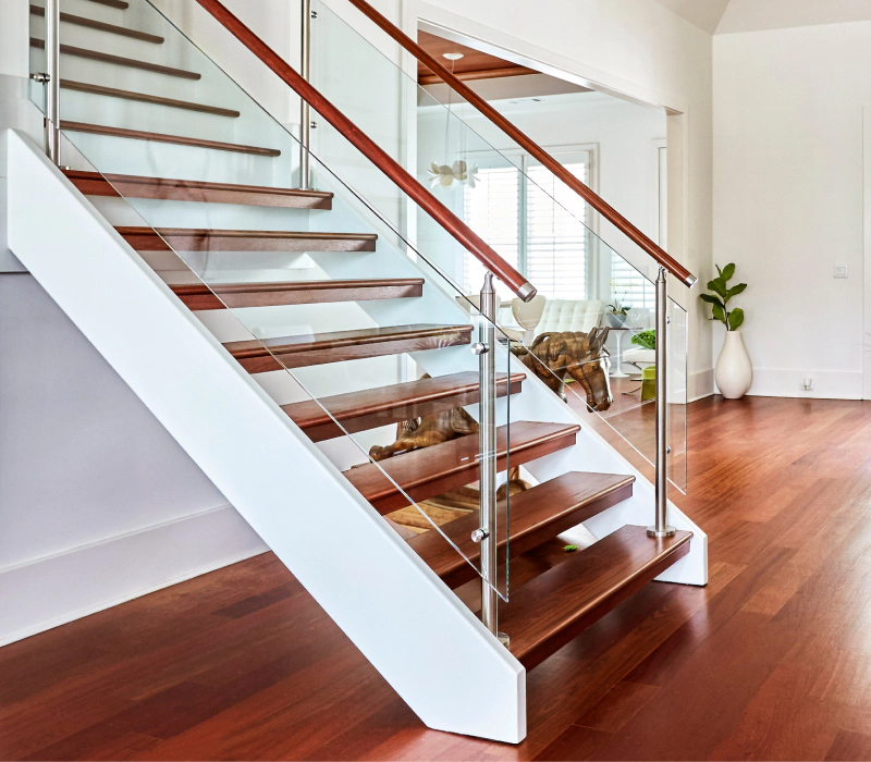 wooden steps and glass railing of floating stairs